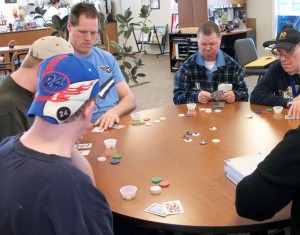 The men in Middlebury's Day Program concentrate on their next move during a Thursday afternoon poker game.
